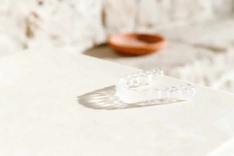 Clear orthodontic aligner on a stone surface